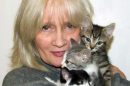 Celia Hammond holding three kittens in her arms