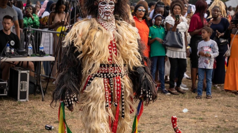 A person in masquerade costume performs