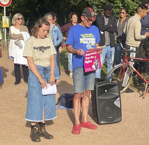 Two people stand at a vigil