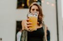 A person holds a pint of beer