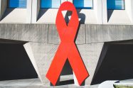 A large red ribbon on a concrete building