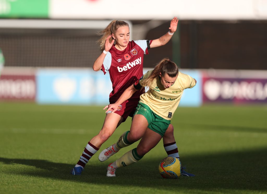 two women footballers clash on the pitch