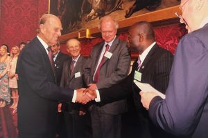 Mickey Ambrose shakes hands with Prince Philip