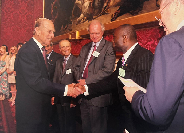 Mickey Ambrose shakes hands with Prince Philip