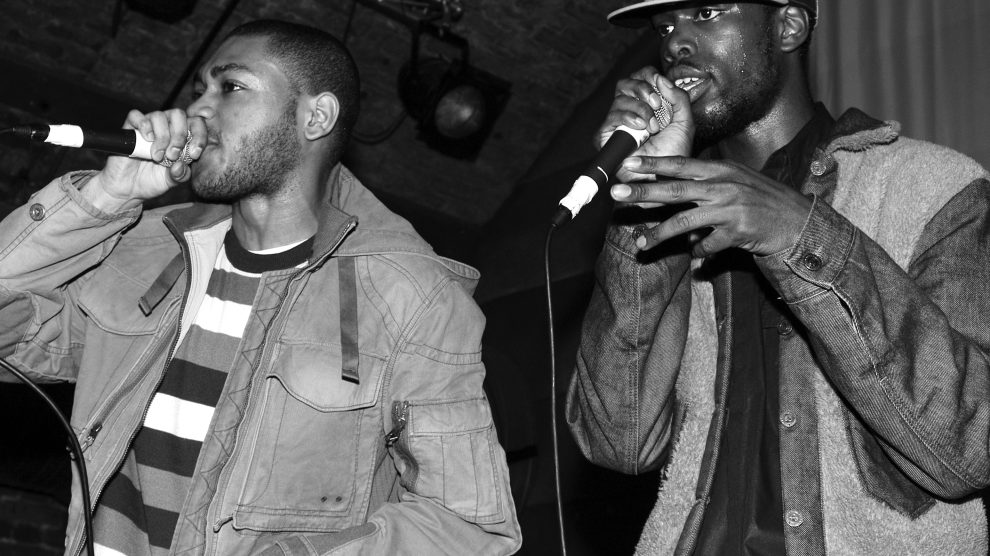 Two men perform with microphones