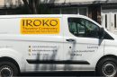The IROKO van, white with a yellow logo on the side