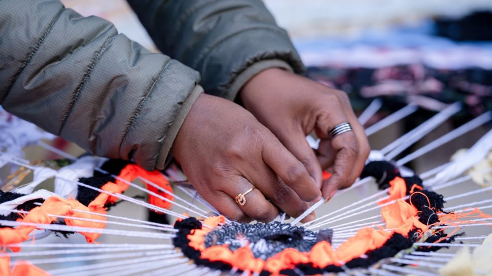 a person weaves