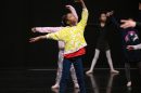 Children practice ballet in a studio