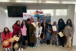A group of people standing holding certificates