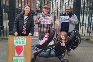 a group of local residents hold placards