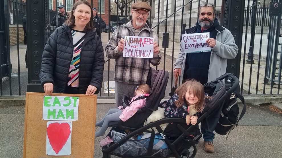 a group of local residents hold placards