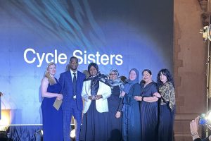 A group of people accept an award onstage
