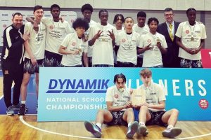 A basketball team pose for the camera