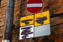parking ristriction signs with black spray paint obscuring them