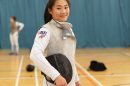 A young fencer in fencing gear