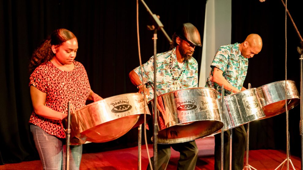 A steel drum band plays