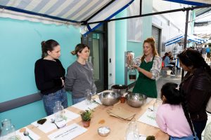 People around a table watch a demonstration