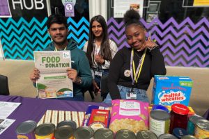 NewVIc's student campaigners pose with a donation of foodsftuffs