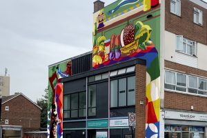 A mock up of a brightly colloured mural on a building
