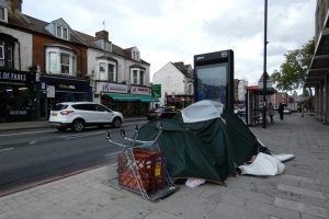 the belongings of someone sleeping rough on a london street