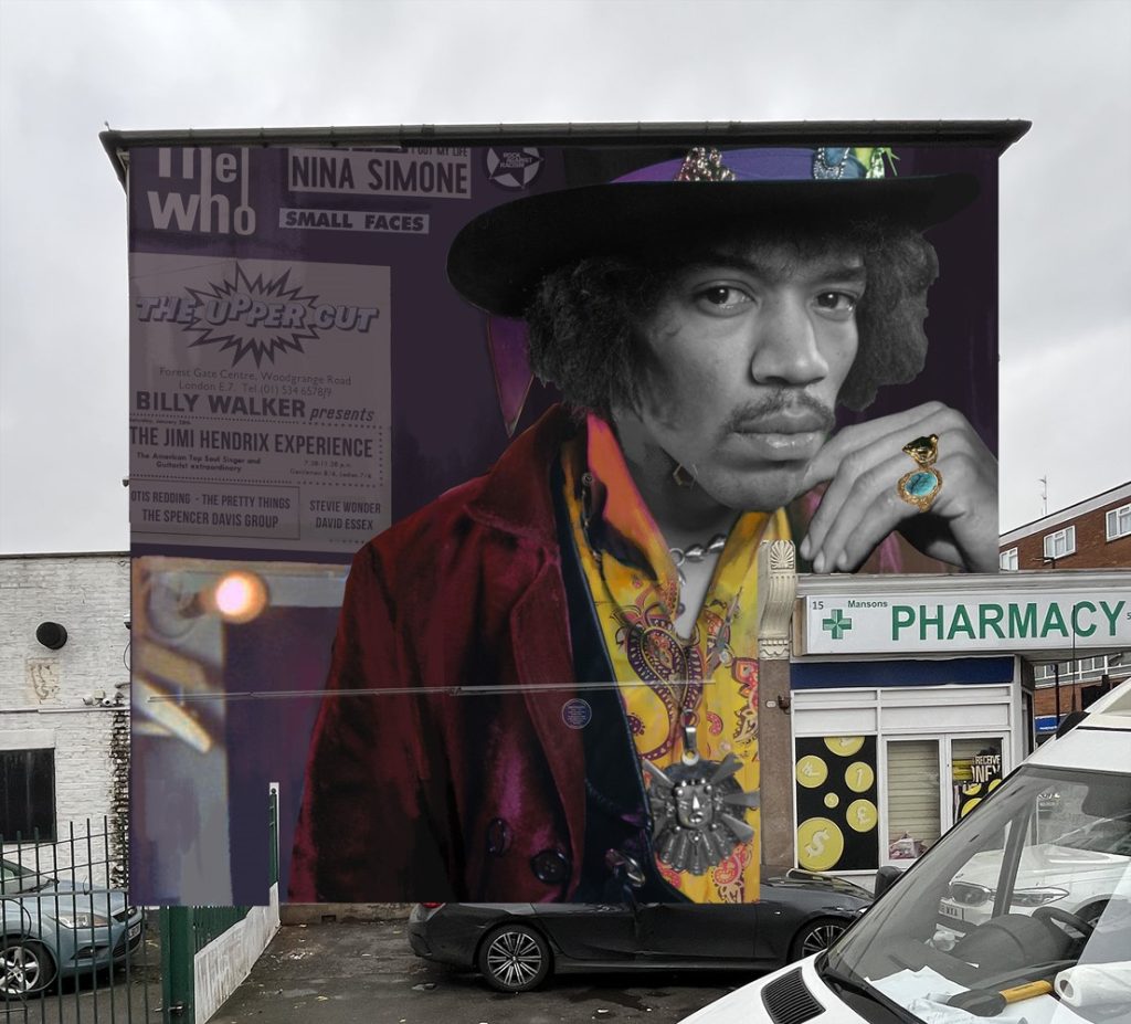A mural of Jimi Hendrix looks down from a wall