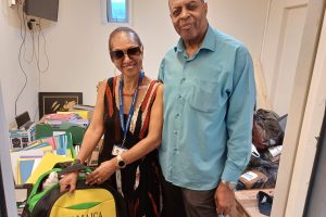 two people pose amonst donated good