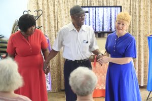 Two performers hold the hands of a third