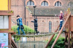 Children play on a rope bridge