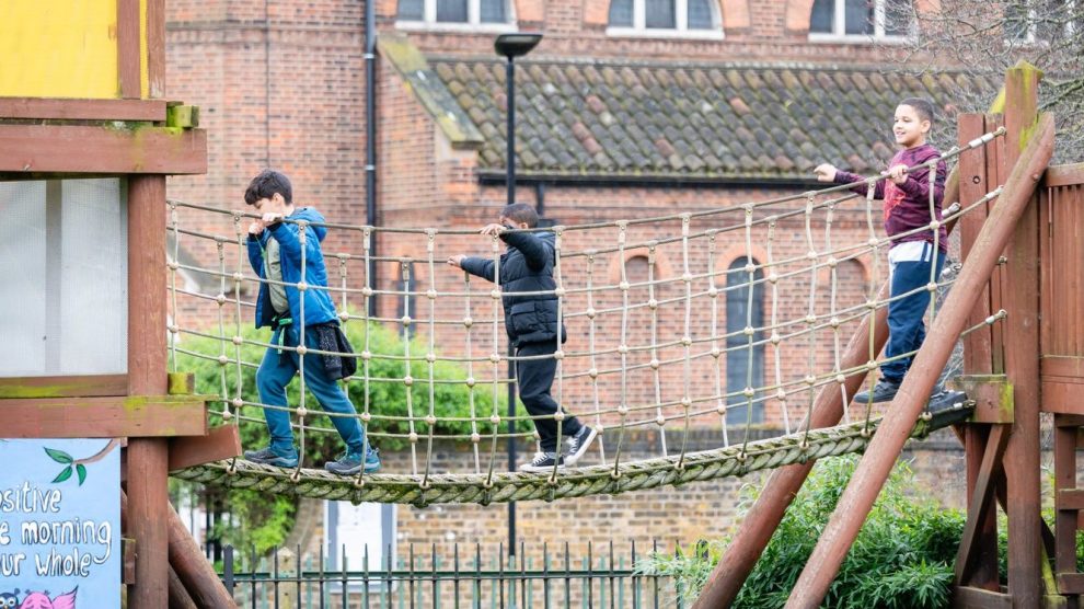Children play on a rope bridge