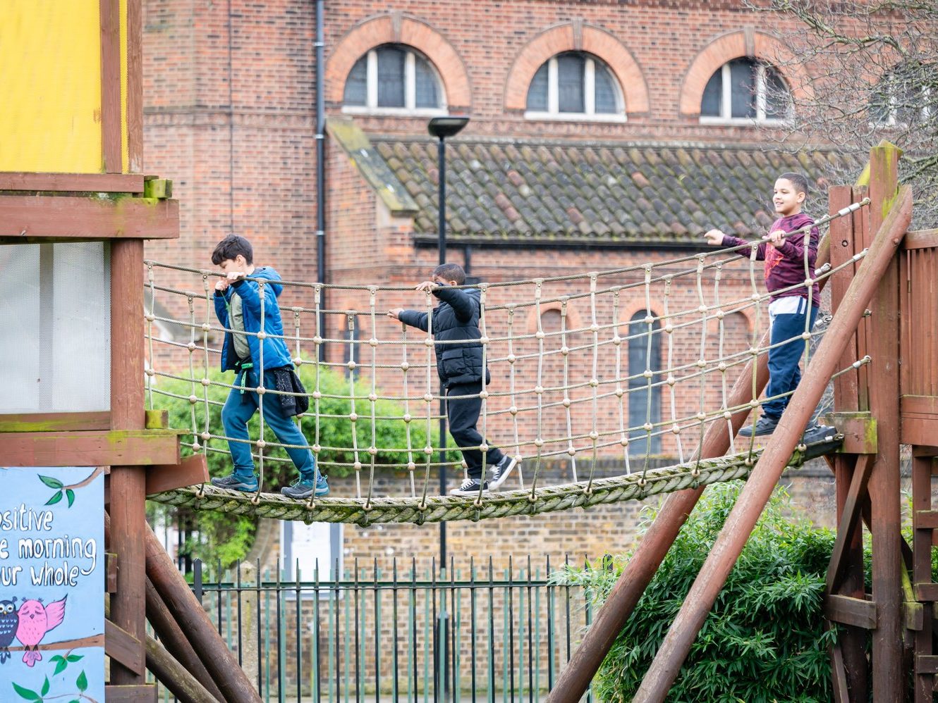 Children play on a rope bridge