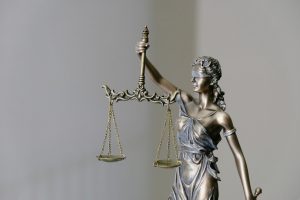 a statue of a figure holding a scales of justice
