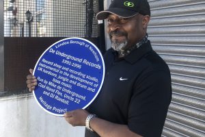 a person holds a blue plaque