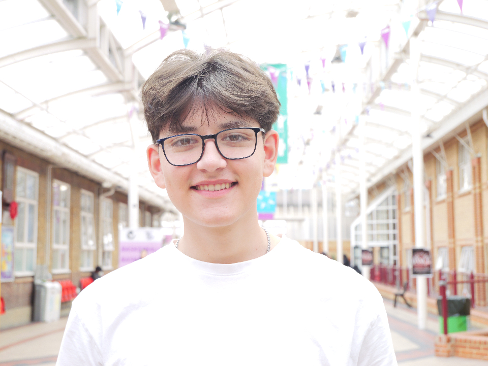 Headshot of a graphic design student wearing glasses