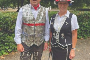 A man and woman dressed as pearly king and queen.