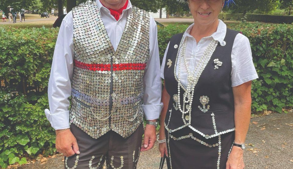 A man and woman dressed as pearly king and queen.