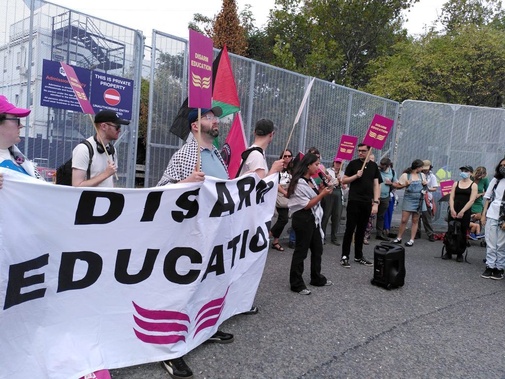 A group of people with a banner and some placards
