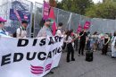 A group of people with a banner and some placards