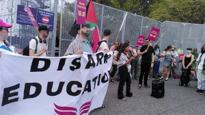 A group of people with a banner and some placards