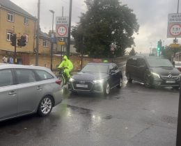 Cars and a cyclist on a road