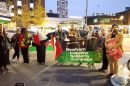 A group of protesters holding flags and banners
