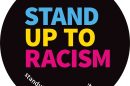 A badge saying Stand Up to Racism