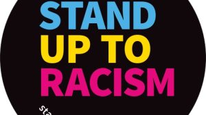 A badge saying Stand Up to Racism