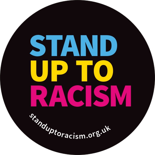 A badge saying Stand Up to Racism
