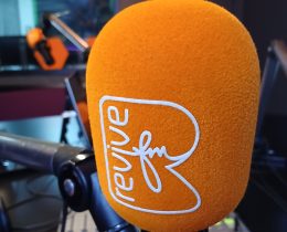 an orange microphone with a revive FM logo