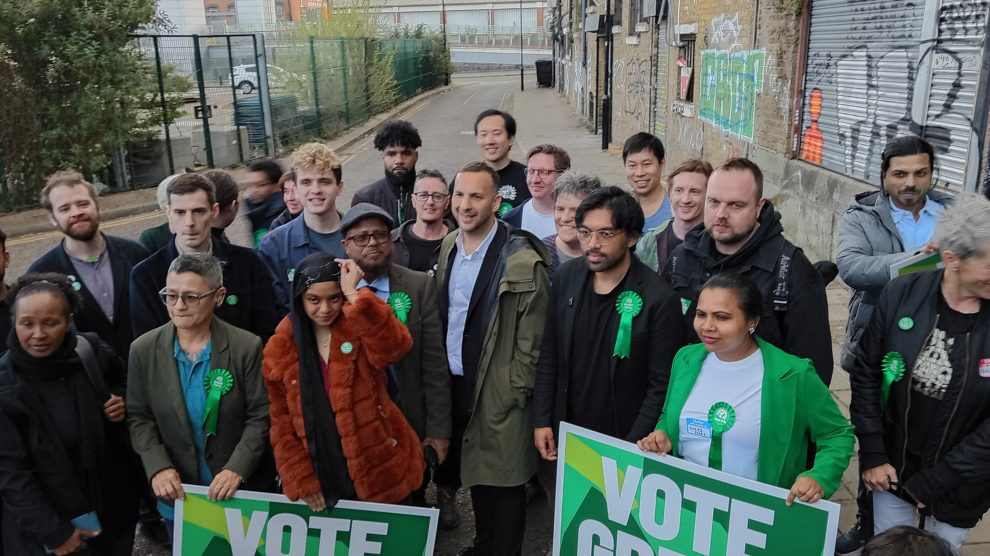 Green Party leader Zack Polanski (centre, brown coat) and to his left Newham mayoral candidate Areeq Choudhury in Stratford (credit Nick Clark/LDRS)