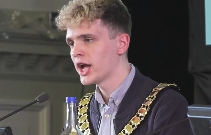 Green councillor Nate Higgins speaks at his first meeting as chair of Newham Council (credit Newham Council)