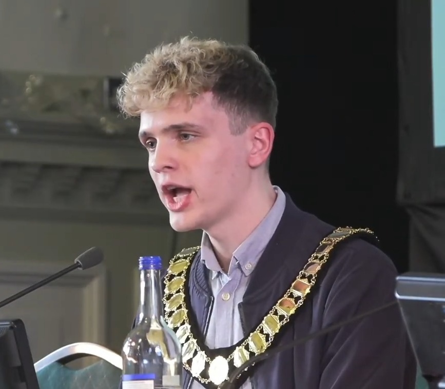 Green councillor Nate Higgins speaks at his first meeting as chair of Newham Council (credit Newham Council)