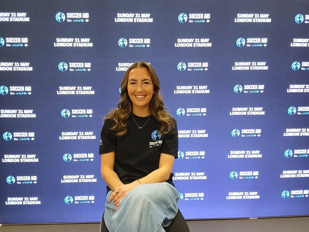 Katie Zelem in front of a promotional backdrop