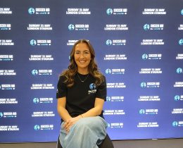 Katie Zelem in front of a promotional backdrop