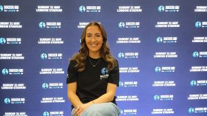 Katie Zelem in front of a promotional backdrop